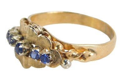 Lot 255 - A sapphire dress ring, the single row of round...
