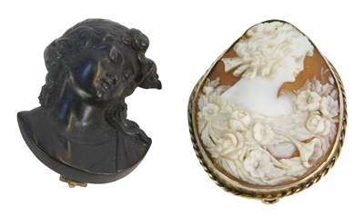 Lot 235A - Two brooches, comprising a carved shell cameo...