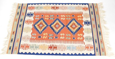 Lot 855 - A Turkish kilim rug, the central red ground...