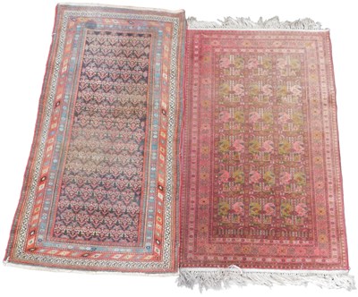 Lot 583 - A Persian rug, red ground with three rows of...