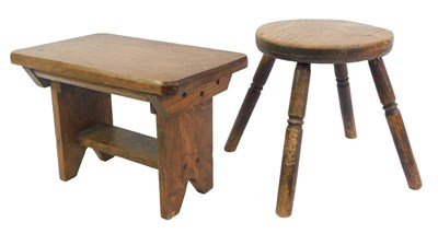 Lot 630 - An elm milking stool, the circular top raised...