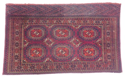Lot 573 - A Turkman rug, red ground, with two rows of...