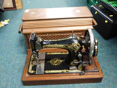 Lot 2106 - A cased Singer sewing machine, serial number...