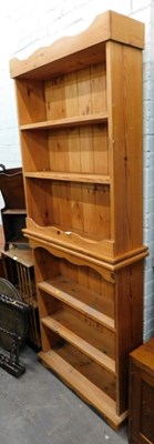 Lot 1503 - A pine three shelf bookcase, with overhanging...