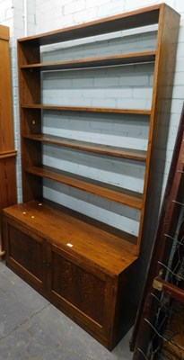 Lot 1504 - An oak four shelf bookcase, over a cupboard...