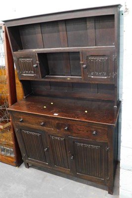 Lot 1515 - An Old Charm style dark oak dresser, the top...