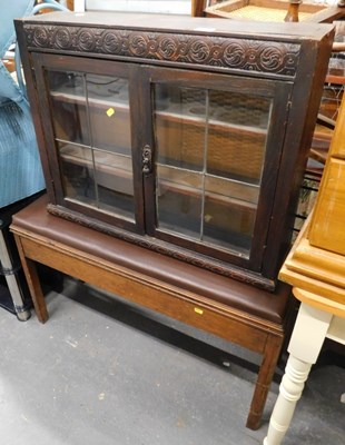 Lot 1517 - A dark oak display cabinet, the top with a...