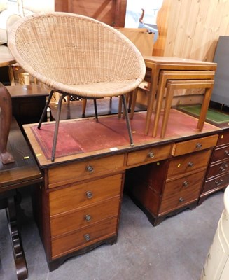 Lot 1598 - A mid century walnut kneehole desk, with red...
