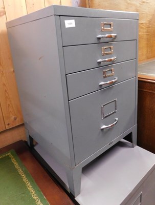 Lot 1599 - A grey filing cabinet, with three shallow...
