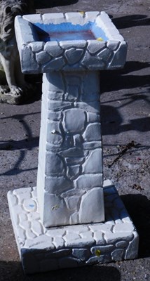 Lot 1653 - A reconstituted stone birdbath, in the form of...