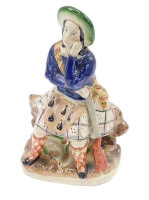 Lot 481 - A 19thC Staffordshire figure of a Scottish...