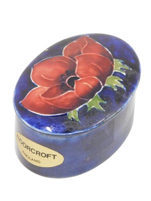 Lot 482 - A Moorcroft oval pin dish, on a dark blue...