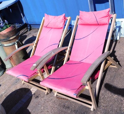 Lot 1660 - A pair of wood framed pink upholstered sun...