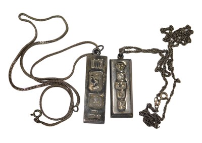 Lot 548 - Two silver ingot pendants, on fine link chains.