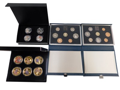 Lot 606 - Four coin sets, comprising the four piece...