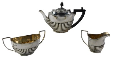 Lot 556 - A George V silver three piece tea set,...