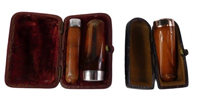 Lot 570 - Three amber cheroot holders, one with a 9ct...