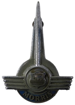 Lot 590 - A Morris Minor car badge, 16cm high.