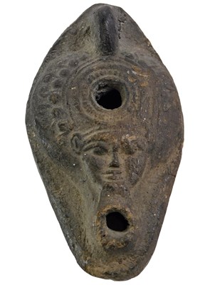 Lot 591 - An Egyptian ceramic oil lamp, decorated with...