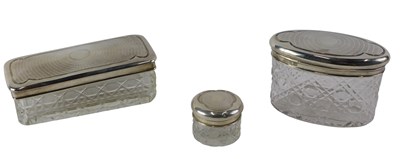 Lot 568 - Three cut glass and silver topped dressing...