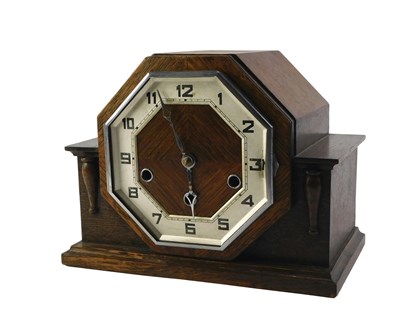 Lot 205 - A 1950s oak cased mantel clock, with an...