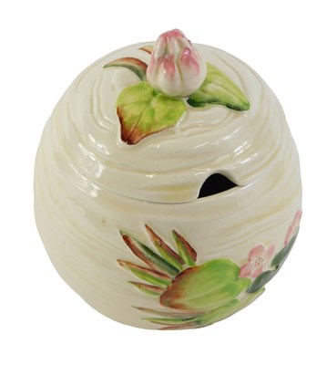Lot 248 - A Clarice Cliff preserve pot and cover, on a...