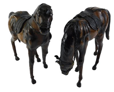Lot 261 - A pair of leather covered horses, in the style...