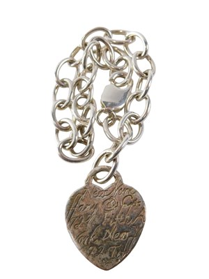 Lot 532 - A silver curb link bracelet, with heart shaped...
