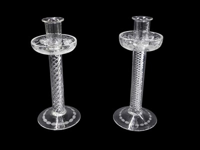 Lot 697 - A pair of clear glass candlesticks, the drip...
