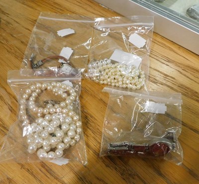 Lot 2190 - Three cultured pearl necklaces and a ring,...