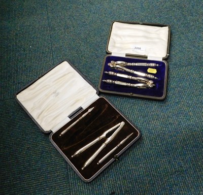 Lot 2208 - A cased set of silver plated nutcrackers, and...