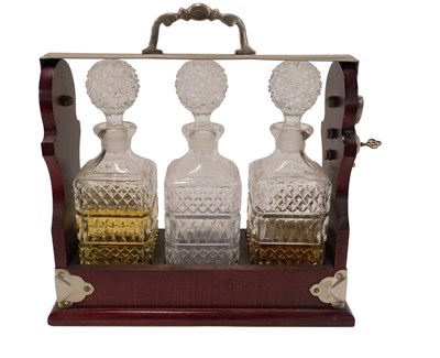 Lot 750 - A mahogany and silver plated tantalus,...