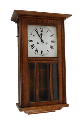 Lot 756 - An oak cased wall clock, the white coloured...