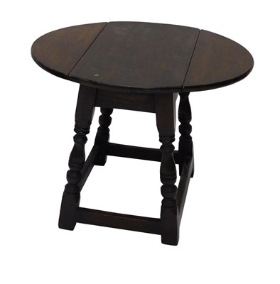 Lot 889 - A small oak drop leaf coffee table, the oval...