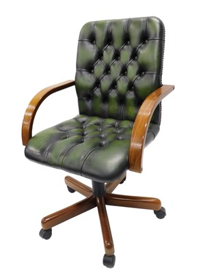 Lot 901 - A green button leather and beech swivel office...