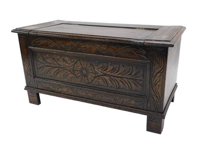 Lot 952 - A carved oak coffer, the hinged lid enclosing...