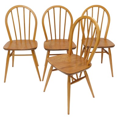 Lot 932 - A set of four Ercol light coloured beech and...