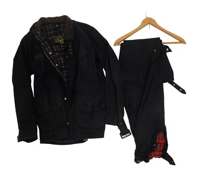 Lot 869 - A blue Barbour wax jacket, a pair of TT dark...