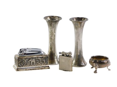 Lot 575b - A white metal mounted desk lighter, the outer...