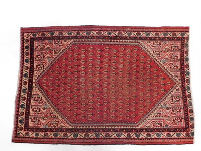 Lot 1013 - A Persian rug, with a design of botei, on a...