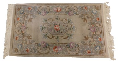 Lot 1025 - A Chinese cut wool rug, with a design of...