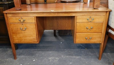 Lot 1533a - A teak kneehole desk, three short drawers to...