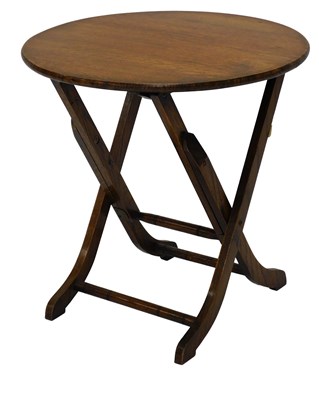 Lot 1030 - An early 20thC oak folding table, the circular...