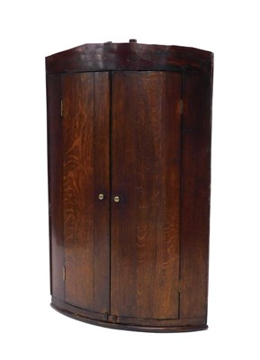 Lot 947 - An early 19thC oak and mahogany bow fronted...