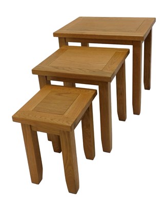 Lot 1001 - A nest of three light oak tables, of plain...