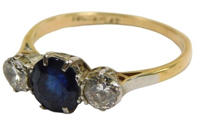 Lot 205 - A sapphire and diamond three stone ring, the...