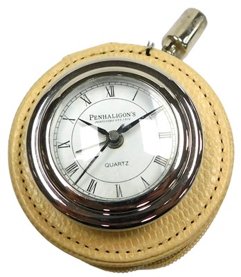 Lot 299 - A Penhaligon's travel clock, circular dial...
