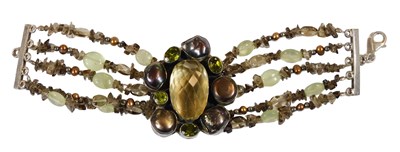 Lot 332 - A four strand bracelet, set centrally with a...