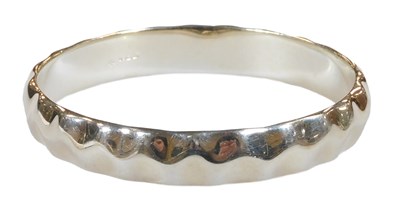 Lot 330 - A silver bangle, of crimped form, millennium...