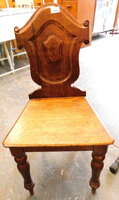 Lot 1008 - A Victorian oak hall chair, with carved back...